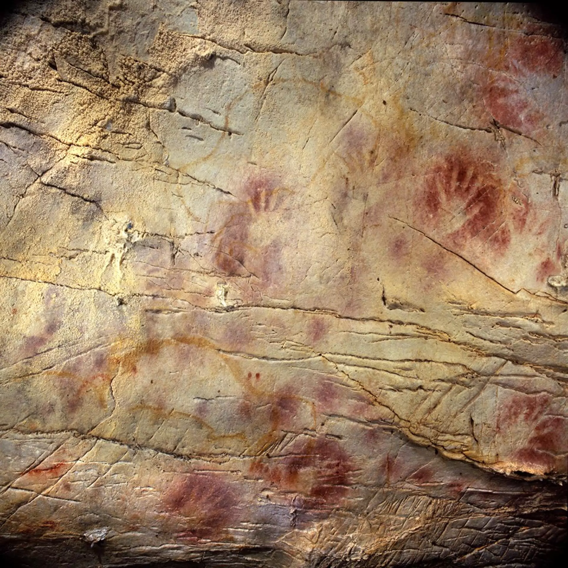 Red ochre handprints, possibly used as an early kind of sunscreen, frequently appear in cave art. This particular artwork in Spain is thought to date back nearly 42,000 years.