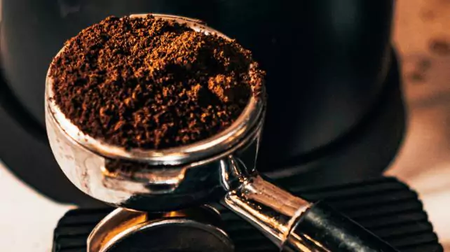 Espresso machine group head filled with coffee grounds