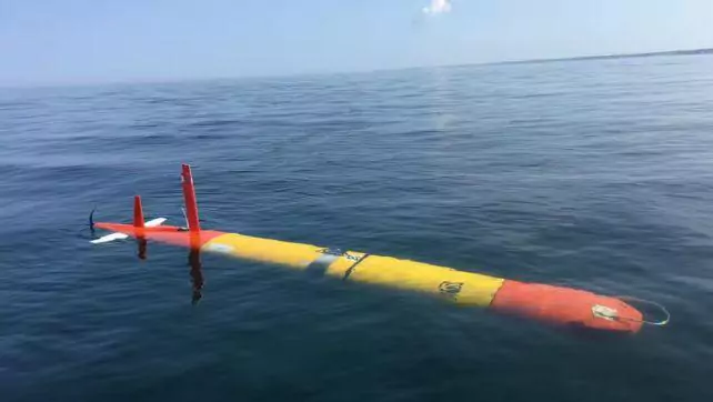 Submersible drone painted in yellow with red-tipped ends