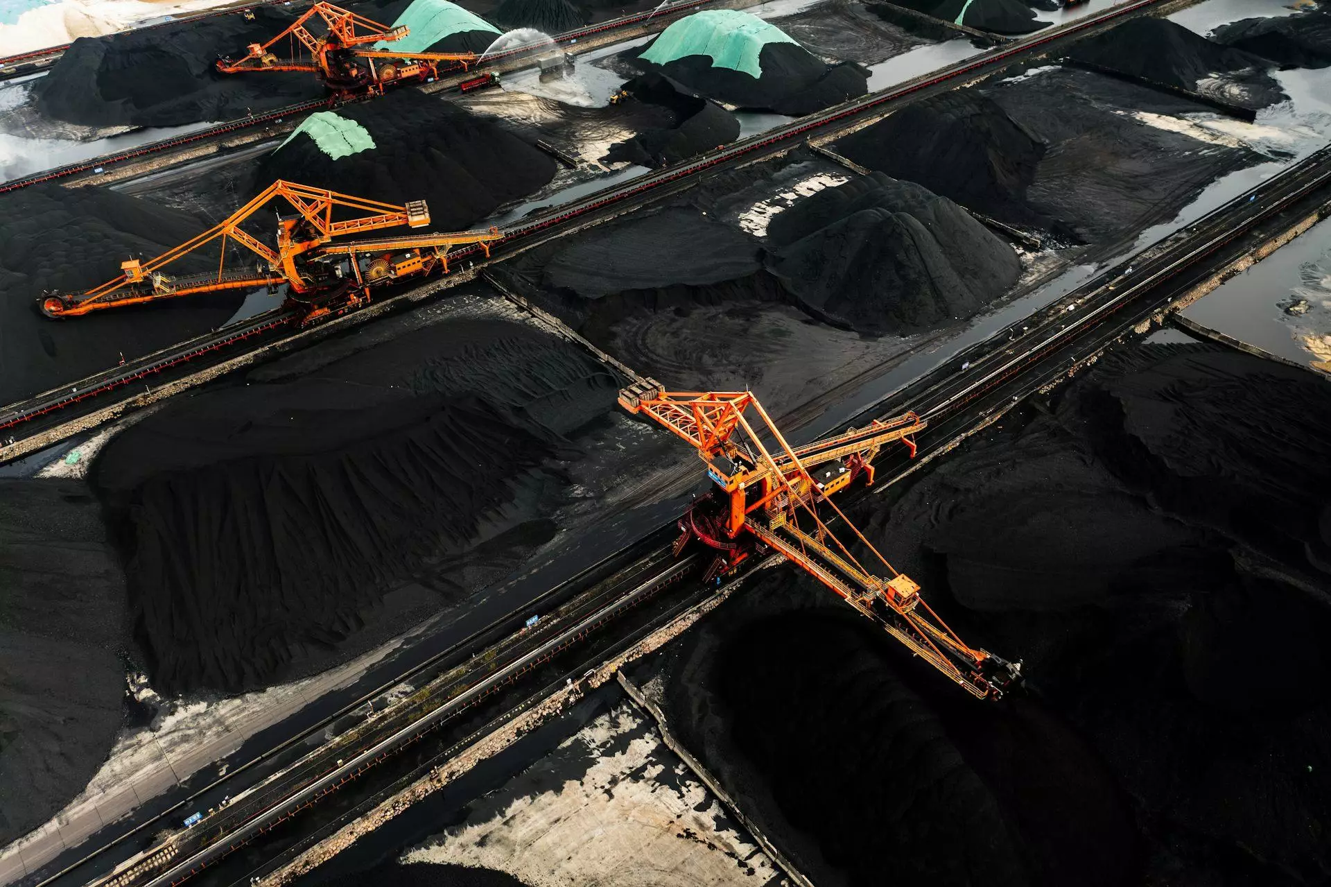 Large mounds of coal with massive excavators