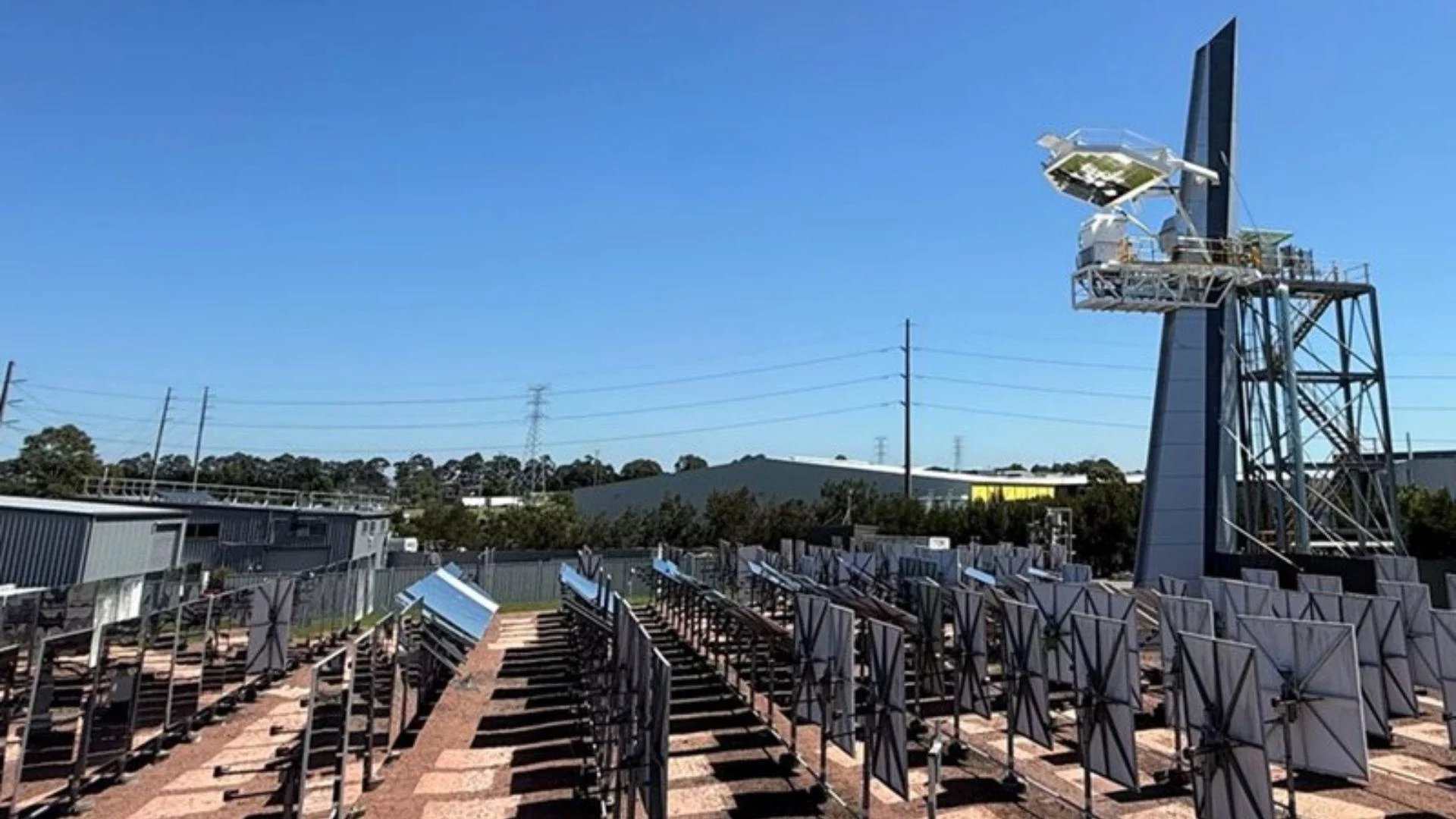Heliostats at CSIRO’s Newcastle Energy Centre follow the sun, directing light onto a central tower to power Australia's inaugural beam-down solar reactor.