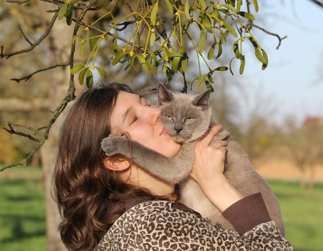 A person embracing a cat